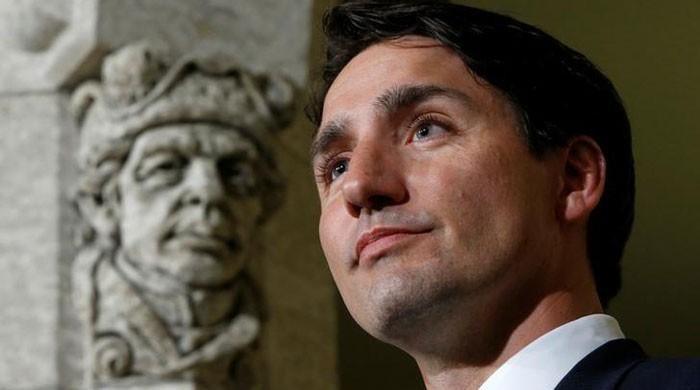 Canada's Trudeau welcomes refugees; U.S.-bound passengers turned away