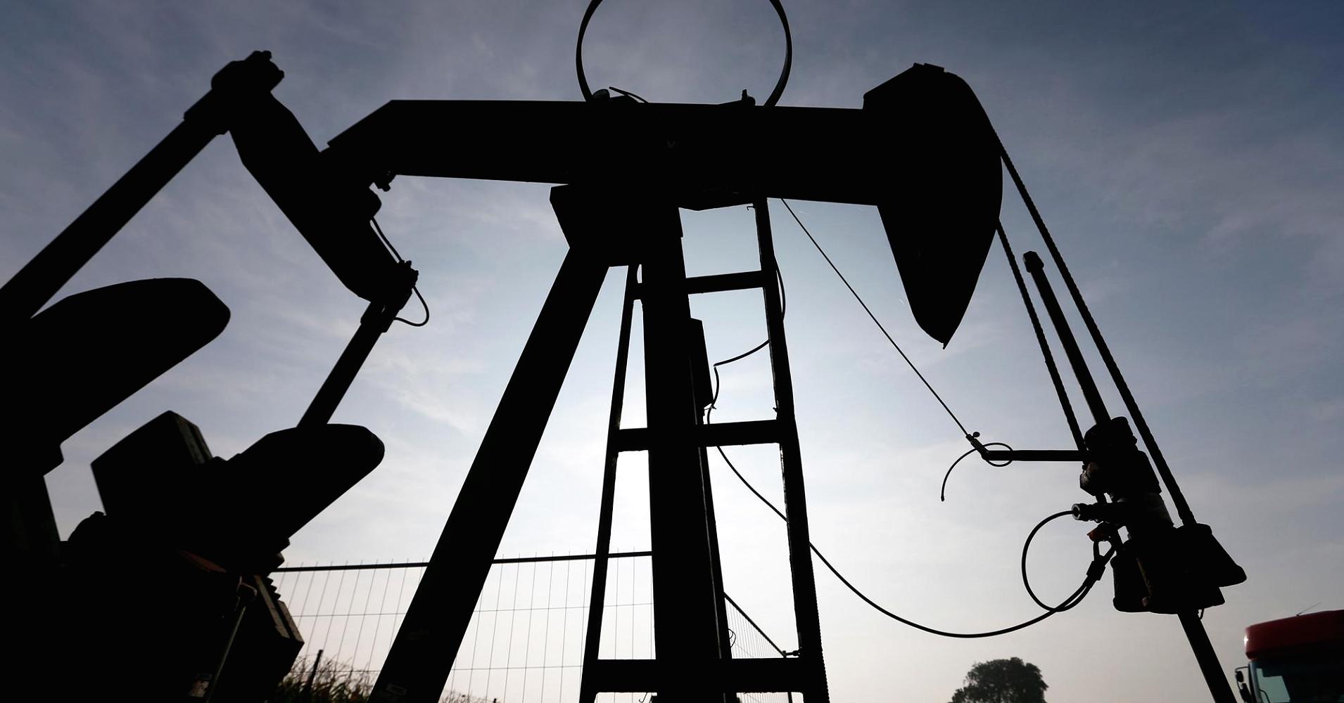 Oil jumps as big U.S. gasoline drawdown offsets crude build