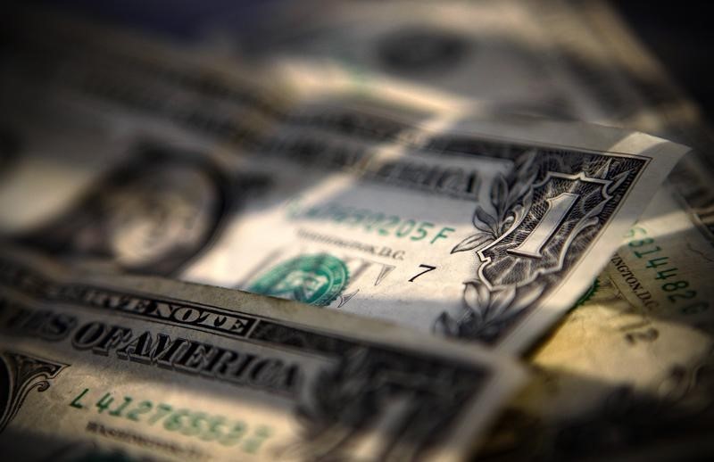 Dollar Drops With Stocks, Bonds Gain Amid Caution
