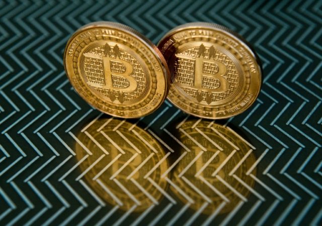Battered bitcoin slides another 12 percent after China warning