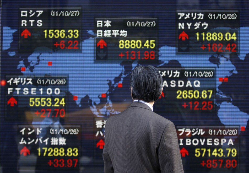 Asia stocks settle near one-year highs on Japan stimulus