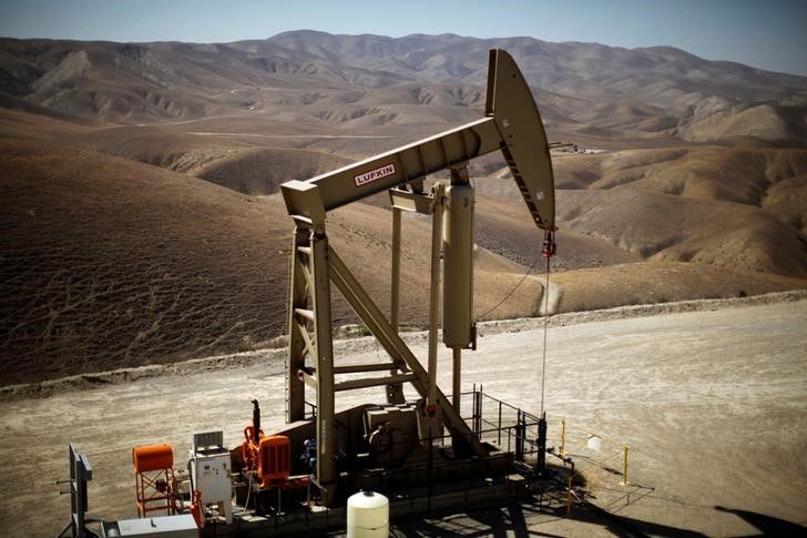 Oil falls on bulging U.S. crude inventories, record global supplies